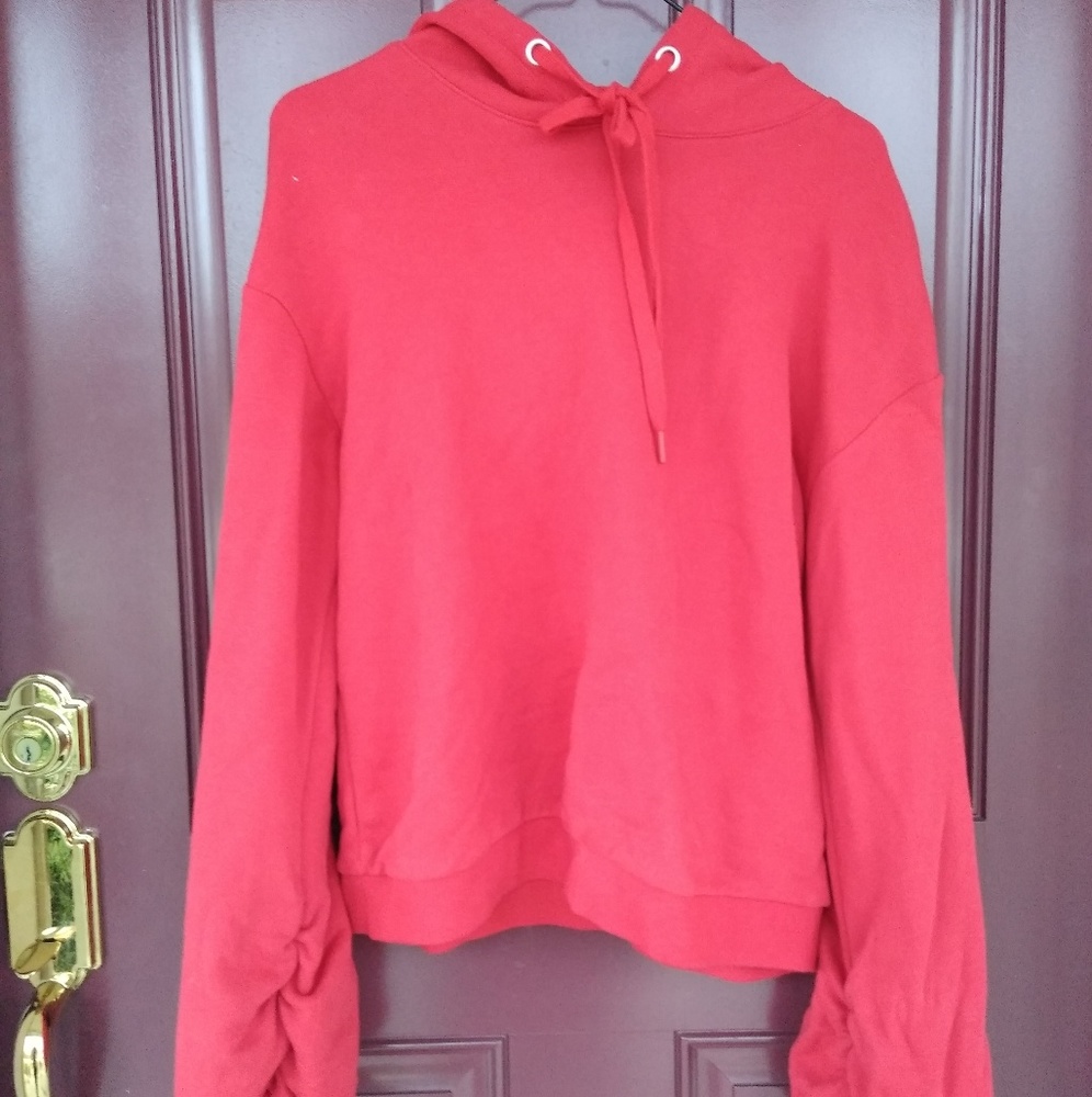 Red sweatshirt with bundled and bell sleeves.
